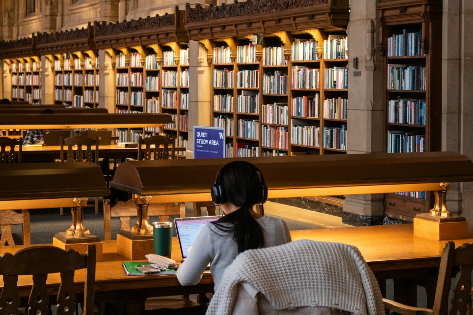 Student studies at a library with books — Photo by Zoshua Colah on Unsplash