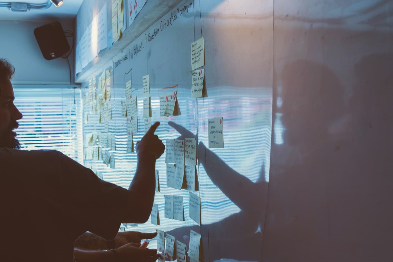 person pointing white paper on wall — Photo by Startaê Team on Unsplash