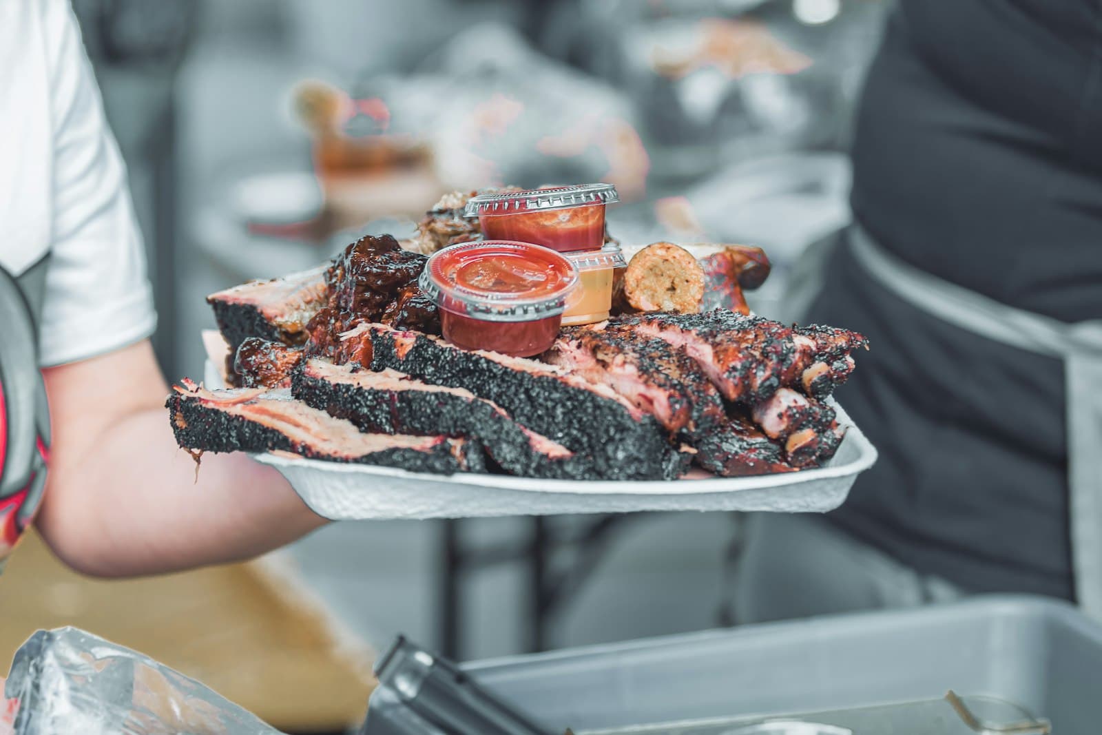 person holding white ceramic tray with sliced of pizza — Photo by Luis Santoyo on Unsplash