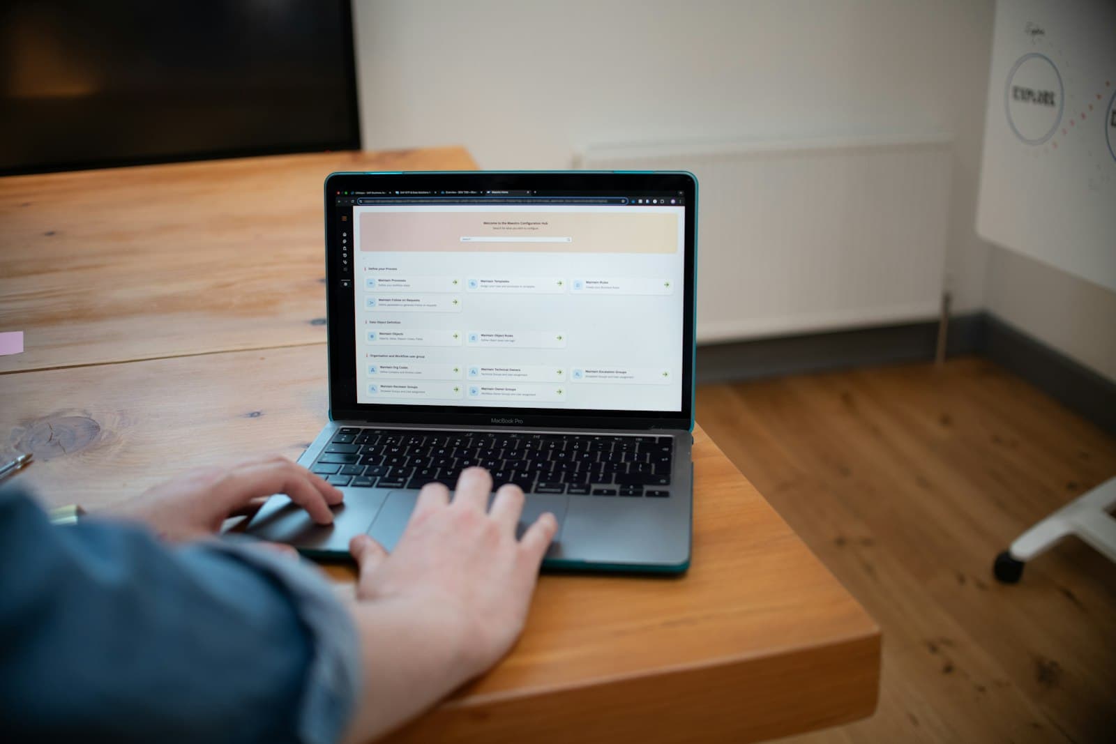 Person typing on a laptop computer on a wooden desk — Photo by Bluestonex on Unsplash